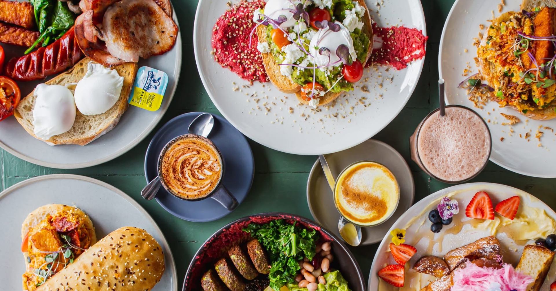 Colorful brunch spread with avocado toast, eggs, and coffee